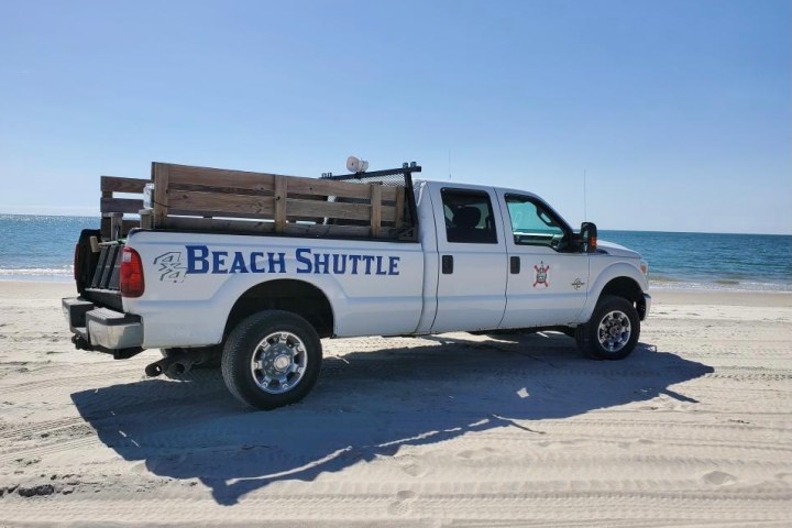 a truck is parked on the beach