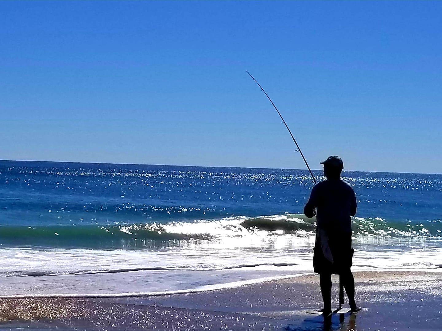 man fishing on beach
