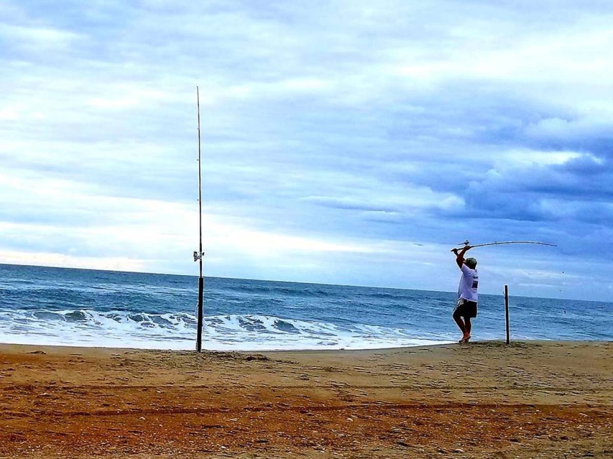 man fishing on beach
