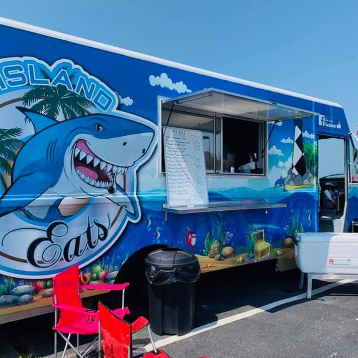 a person standing in front of a blue truck